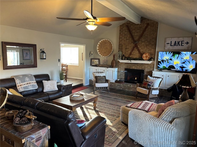 living area featuring a ceiling fan, lofted ceiling with beams, baseboards, a brick fireplace, and dark wood-style flooring