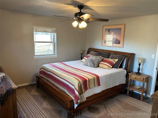 bedroom featuring baseboards and ceiling fan