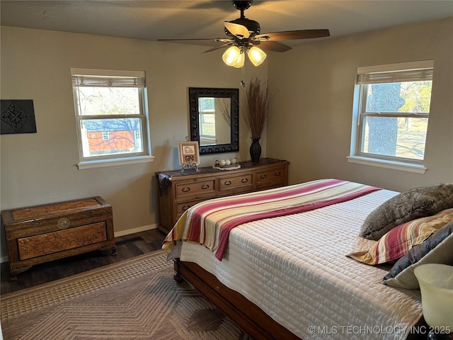 bedroom featuring a ceiling fan, baseboards, and wood finished floors