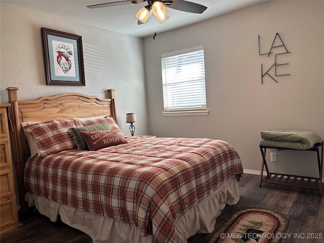 bedroom with dark wood-style floors, baseboards, and a ceiling fan