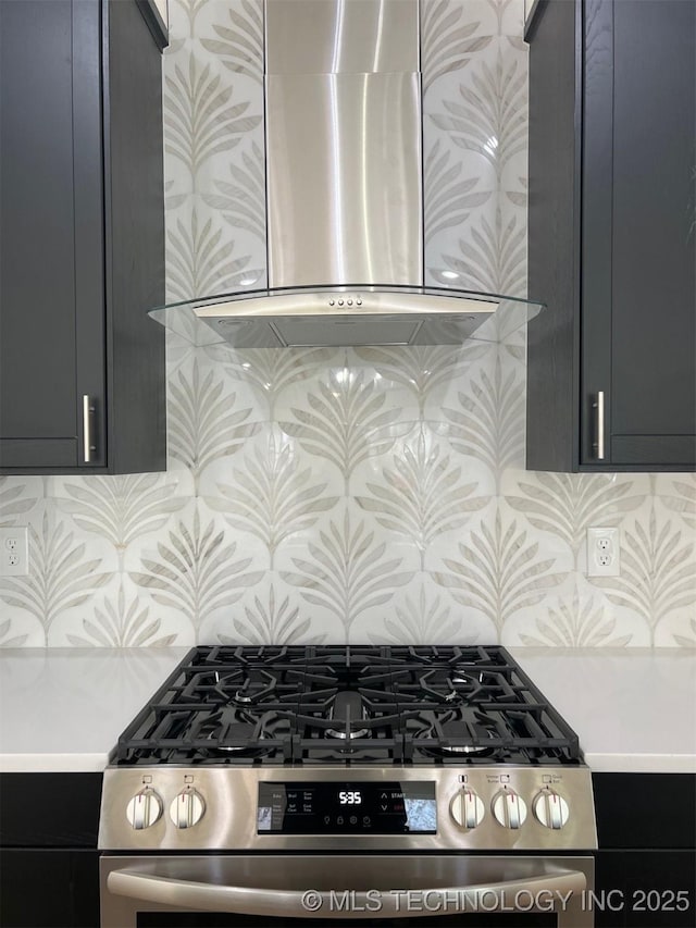 kitchen with light countertops, wall chimney range hood, backsplash, and stainless steel gas range