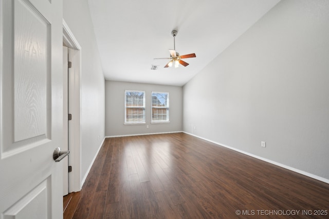 empty room featuring dark wood finished floors, visible vents, baseboards, and ceiling fan