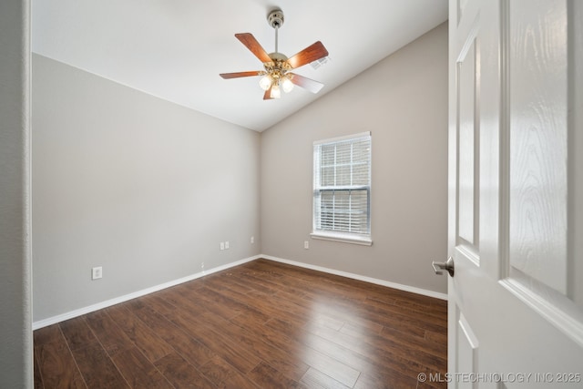 spare room featuring a ceiling fan, baseboards, visible vents, dark wood finished floors, and vaulted ceiling