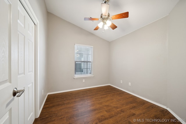 unfurnished room featuring ceiling fan, baseboards, dark wood-style floors, and vaulted ceiling