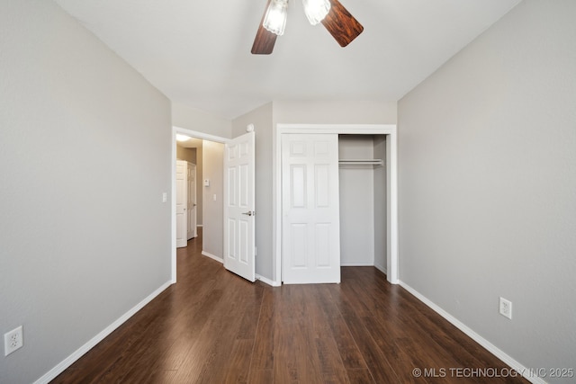 unfurnished bedroom featuring a closet, baseboards, wood finished floors, and a ceiling fan