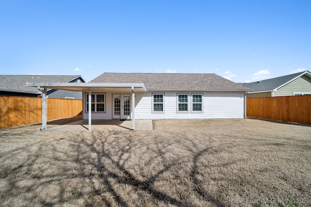 back of house with a patio area, french doors, a shingled roof, and a fenced backyard