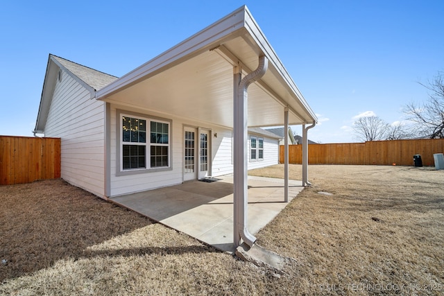 rear view of house featuring a patio area and a fenced backyard