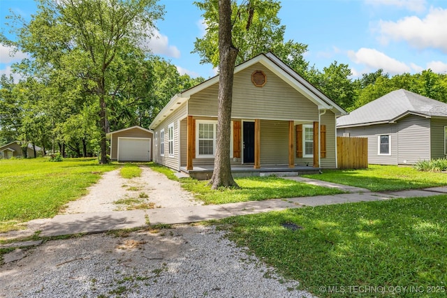 311 W 6th, Ada, OK 74820 - view of front of property featuring dirt driveway, a porch, an outdoor structure, and a garage