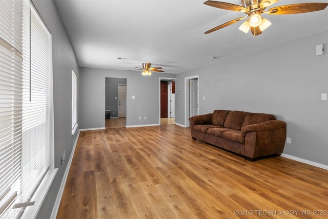 311 W 6th, Ada, OK 74820 - living area with ceiling fan and light wood-style floors