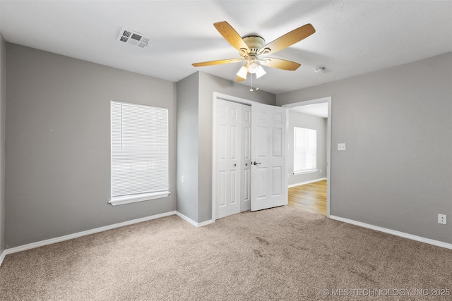 311 W 6th, Ada, OK 74820 - unfurnished bedroom featuring carpet flooring, a closet, and ceiling fan