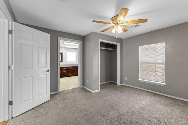 311 W 6th, Ada, OK 74820 - unfurnished bedroom featuring carpet floors, a closet, ceiling fan, and ensuite bathroom