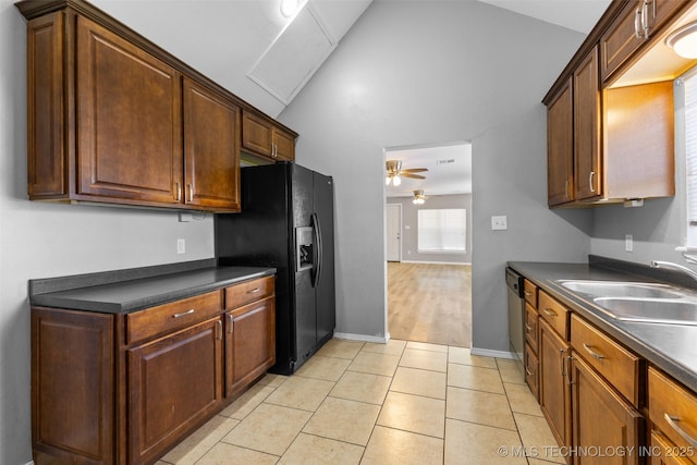 311 W 6th, Ada, OK 74820 - kitchen featuring dark countertops, a ceiling fan, black fridge, light tile patterned floors, and stainless steel dishwasher