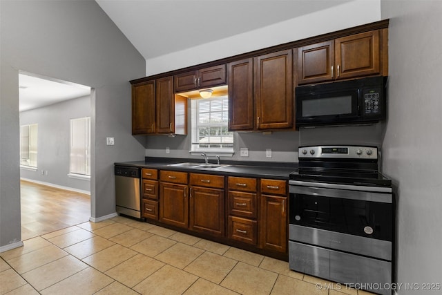 311 W 6th, Ada, OK 74820 - kitchen featuring appliances with stainless steel finishes, dark countertops, vaulted ceiling, light tile patterned floors, and dark brown cabinetry