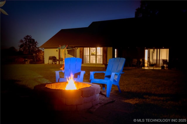 patio at night with a fire pit