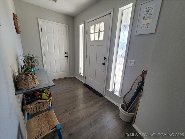 entrance foyer with a wealth of natural light, baseboards, and dark wood-style flooring