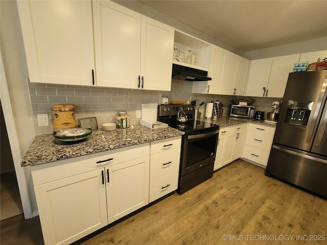 kitchen with stainless steel microwave, under cabinet range hood, refrigerator with ice dispenser, range with electric stovetop, and wood finished floors