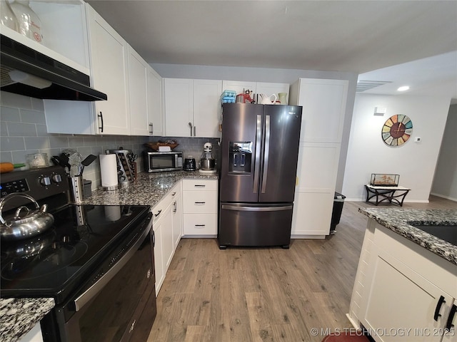 kitchen with white cabinetry, tasteful backsplash, under cabinet range hood, and stainless steel appliances