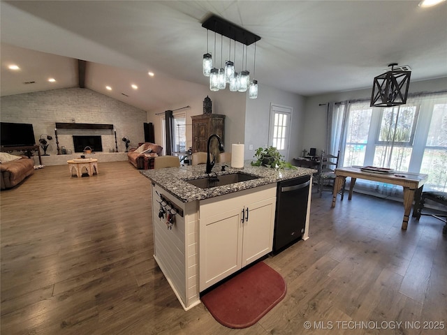 kitchen featuring a sink, black dishwasher, open floor plan, wood-type flooring, and vaulted ceiling with beams