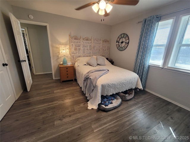 bedroom featuring a ceiling fan, wood finished floors, and baseboards