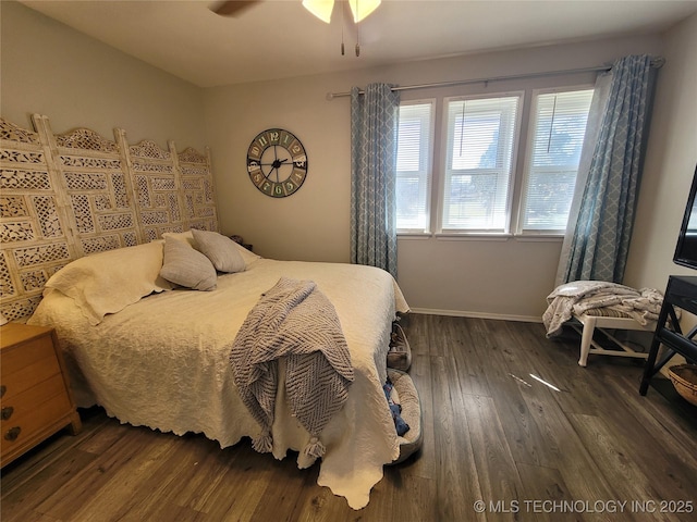 bedroom featuring a ceiling fan, dark wood-type flooring, and baseboards