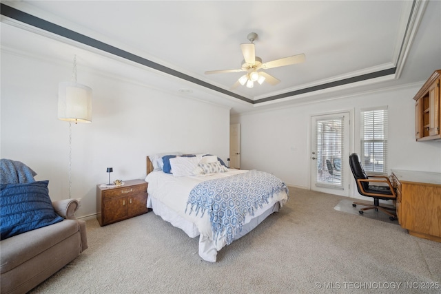 bedroom with light carpet, crown molding, a raised ceiling, and access to exterior