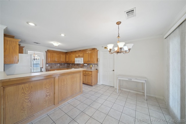 kitchen featuring white appliances, visible vents, an inviting chandelier, ornamental molding, and light countertops