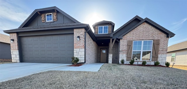 craftsman house with brick siding, an attached garage, and driveway