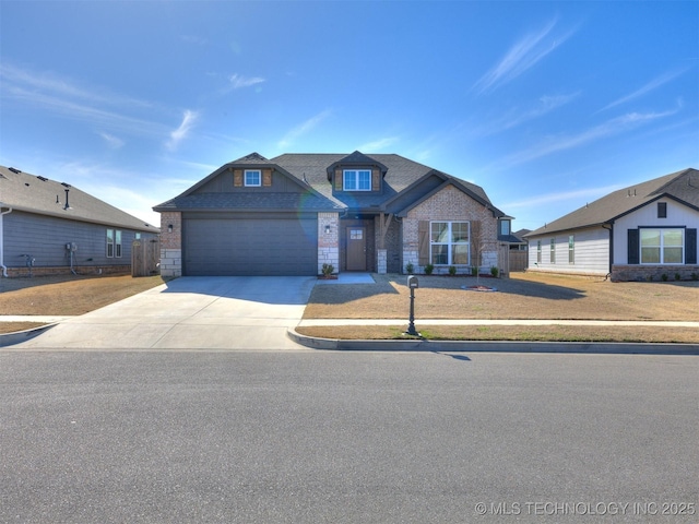 craftsman-style home featuring brick siding, an attached garage, fence, stone siding, and driveway