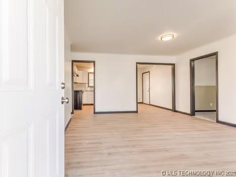 unfurnished bedroom featuring baseboards and light wood finished floors