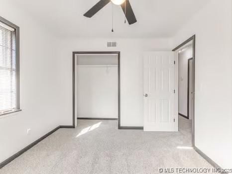 unfurnished bedroom with a closet, visible vents, baseboards, and carpet floors