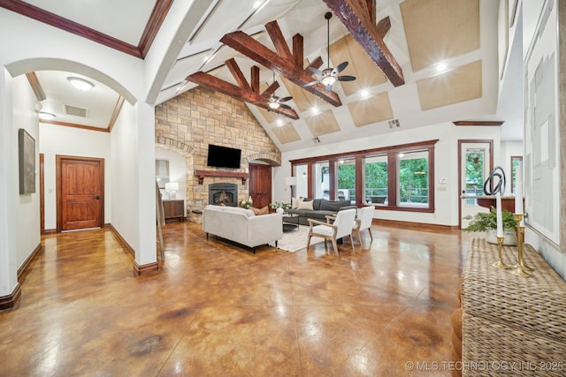 1721 E 136th Pl S, Bixby, OK 74008 - living room with a ceiling fan, a stone fireplace, high vaulted ceiling, beam ceiling, and arched walkways