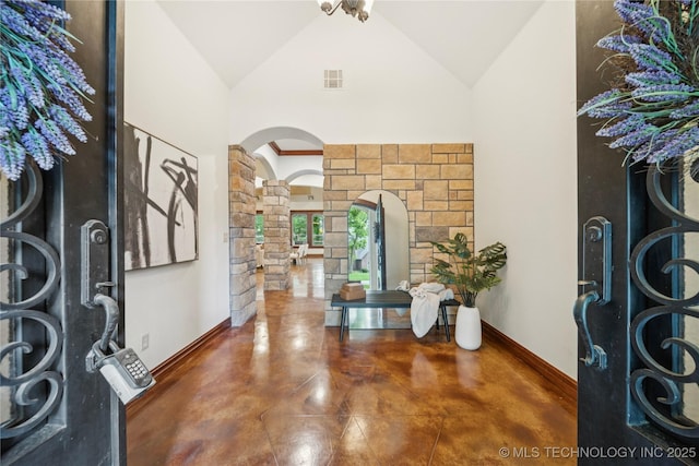 1721 E 136th Pl S, Bixby, OK 74008 - foyer with decorative columns, arched walkways, concrete floors, high vaulted ceiling, and baseboards