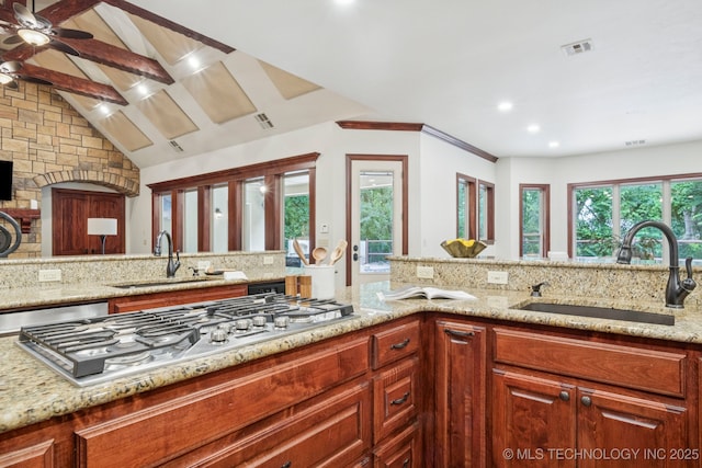 1721 E 136th Pl S, Bixby, OK 74008 - kitchen featuring stainless steel gas stovetop, light stone counters, ceiling fan, recessed lighting, and vaulted ceiling