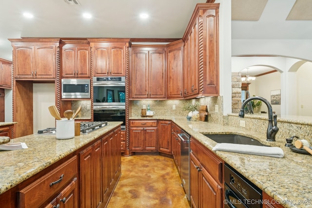 1721 E 136th Pl S, Bixby, OK 74008 - kitchen with appliances with stainless steel finishes, concrete floors, decorative backsplash, light stone countertops, and arched walkways