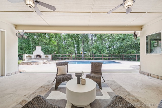 1721 E 136th Pl S, Bixby, OK 74008 - view of patio with a ceiling fan, an outdoor stone fireplace, and view of scattered trees