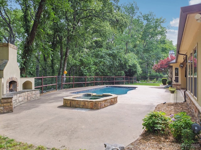 1721 E 136th Pl S, Bixby, OK 74008 - view of pool featuring an outdoor stone fireplace, a patio area, a pool with connected hot tub, and view of scattered trees