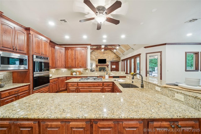 1721 E 136th Pl S, Bixby, OK 74008 - kitchen with a sink, stainless steel appliances, a ceiling fan, tasteful backsplash, and a large island with sink