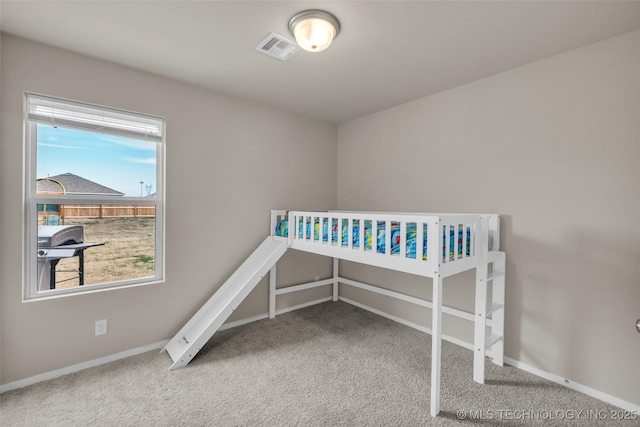 carpeted bedroom with visible vents and baseboards