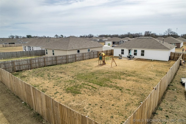 view of yard with a residential view and a fenced backyard