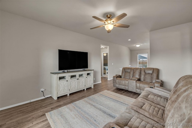 living room with baseboards, wood finished floors, and a ceiling fan