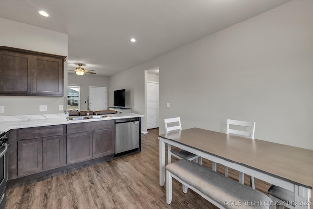 kitchen featuring light wood-type flooring, a ceiling fan, light countertops, dark brown cabinets, and dishwasher