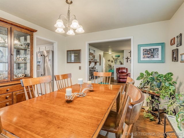 dining area featuring a notable chandelier and wood finished floors