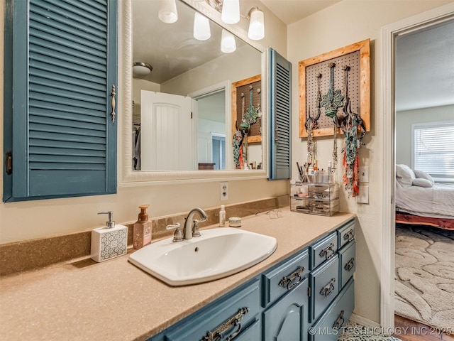 ensuite bathroom with vanity and connected bathroom