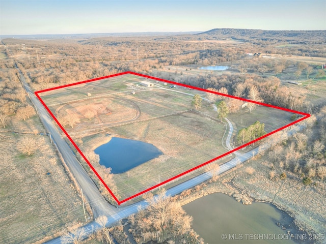 birds eye view of property featuring a rural view and a water view