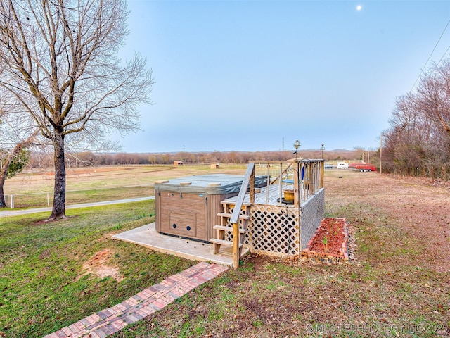 view of yard with a wooden deck and a hot tub