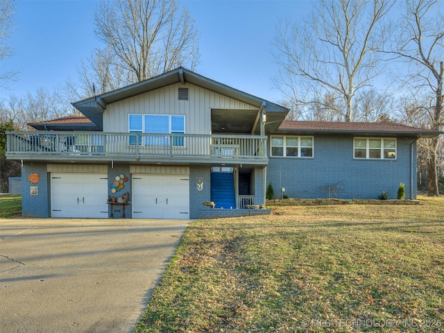 view of front facade featuring concrete driveway, an attached garage, a front yard, a balcony, and brick siding