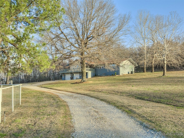 view of front of property with dirt driveway and stucco siding