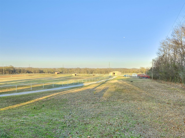 view of yard with a rural view and fence