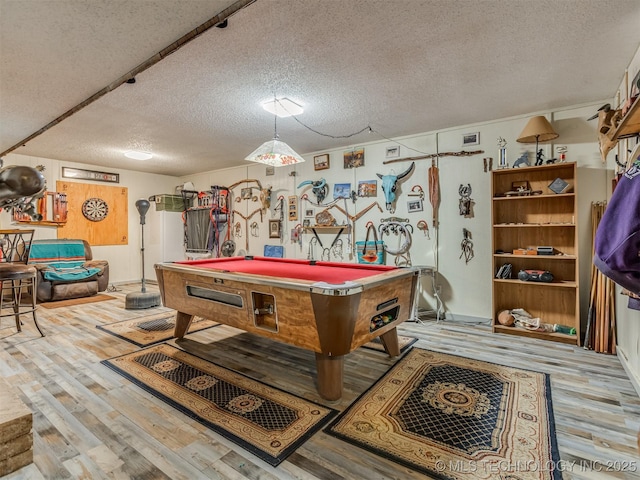 recreation room with billiards, wood finished floors, and a textured ceiling