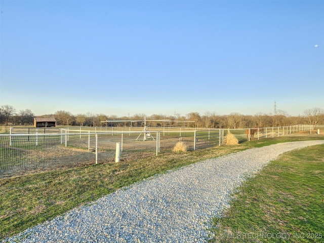 view of yard with a rural view and fence